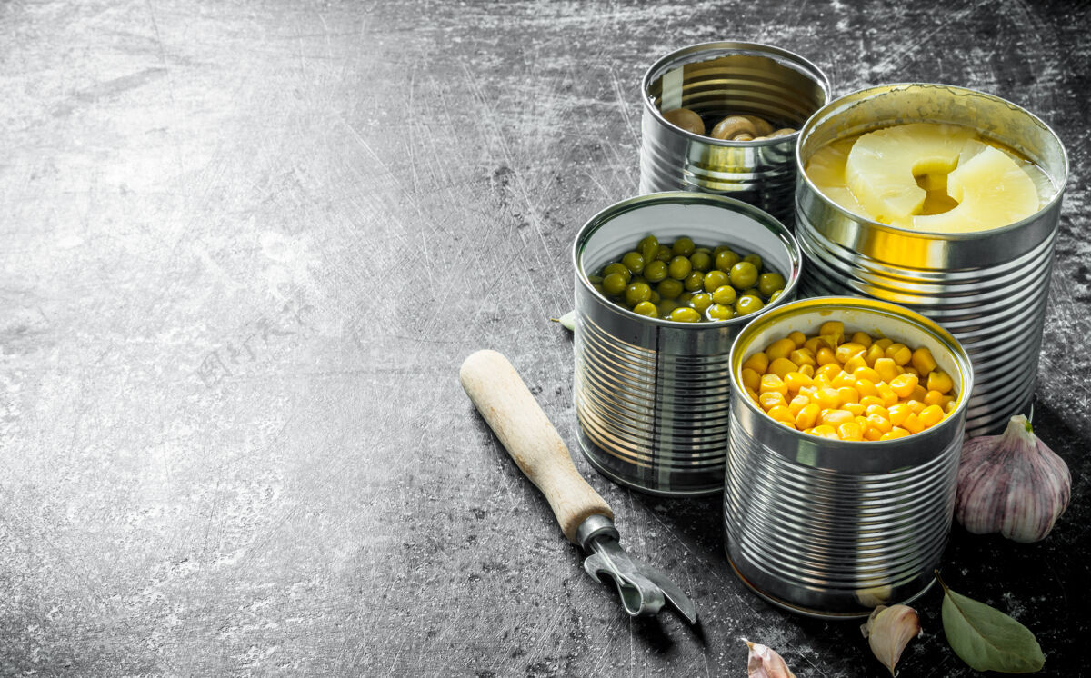 品种菠萝罐头 青豆罐头 玉米罐头和蘑菇罐头放在乡村的桌子上储藏圆筒铝