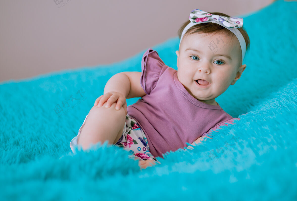 小可爱时尚的六个月大的宝宝张开嘴看着相机美丽快乐女性