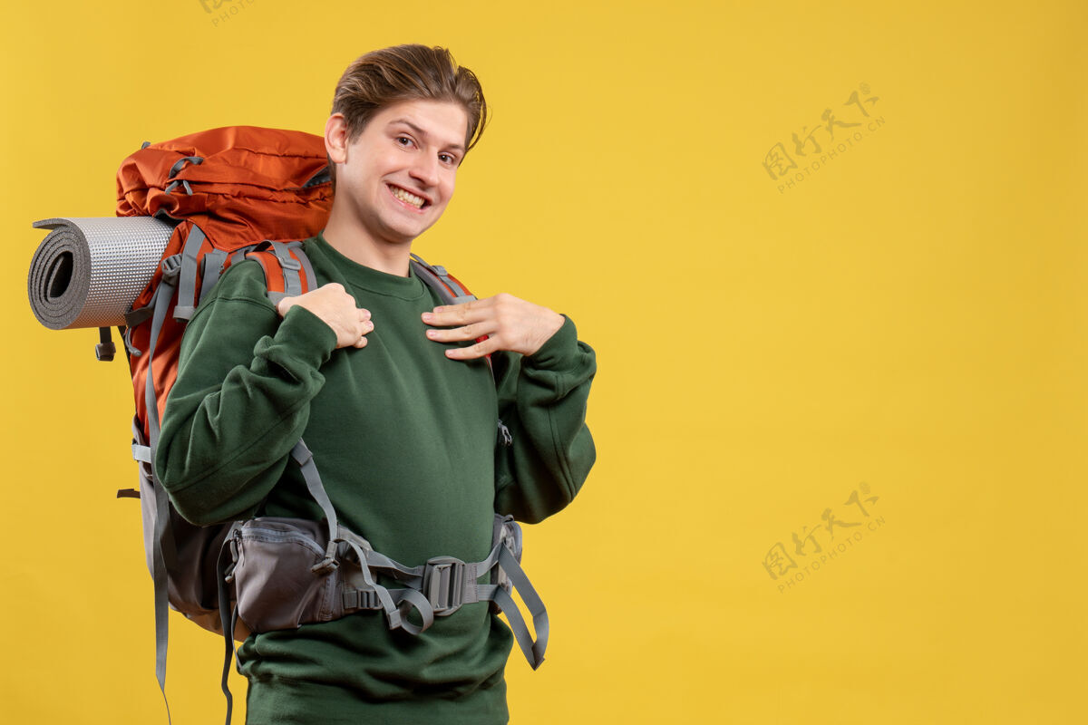 黄色正面图年轻男子背着背包准备远足背包冒险自然