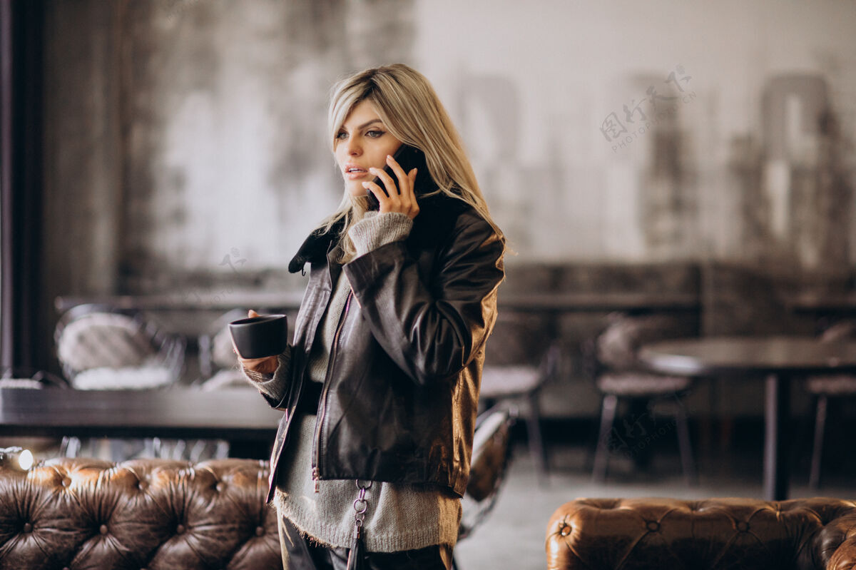 成功在咖啡馆喝咖啡打电话的年轻女人女性社交微笑