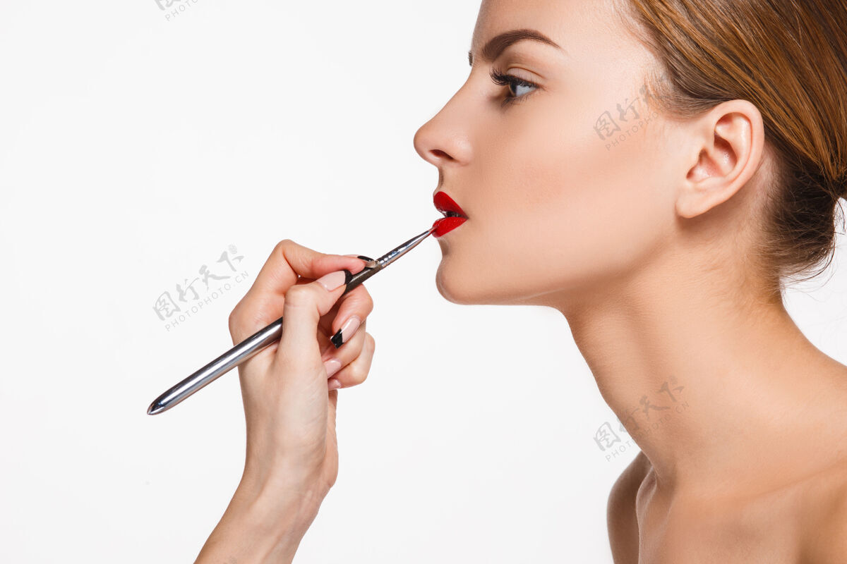 工作美丽的女性唇妆与刷白化妆师的工作过程皮肤艺术家眼影