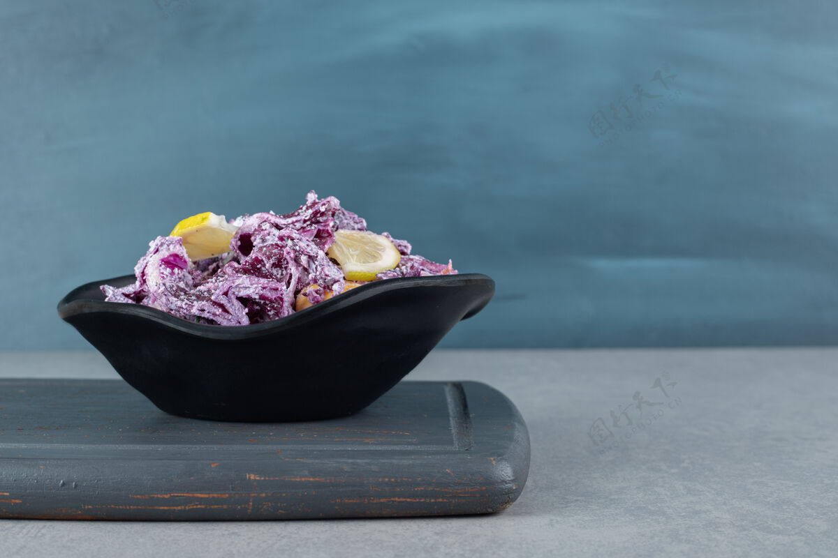 晚餐切碎的紫洋葱和卷心菜沙拉放在水泥桌上的盘子里美味正餐季节