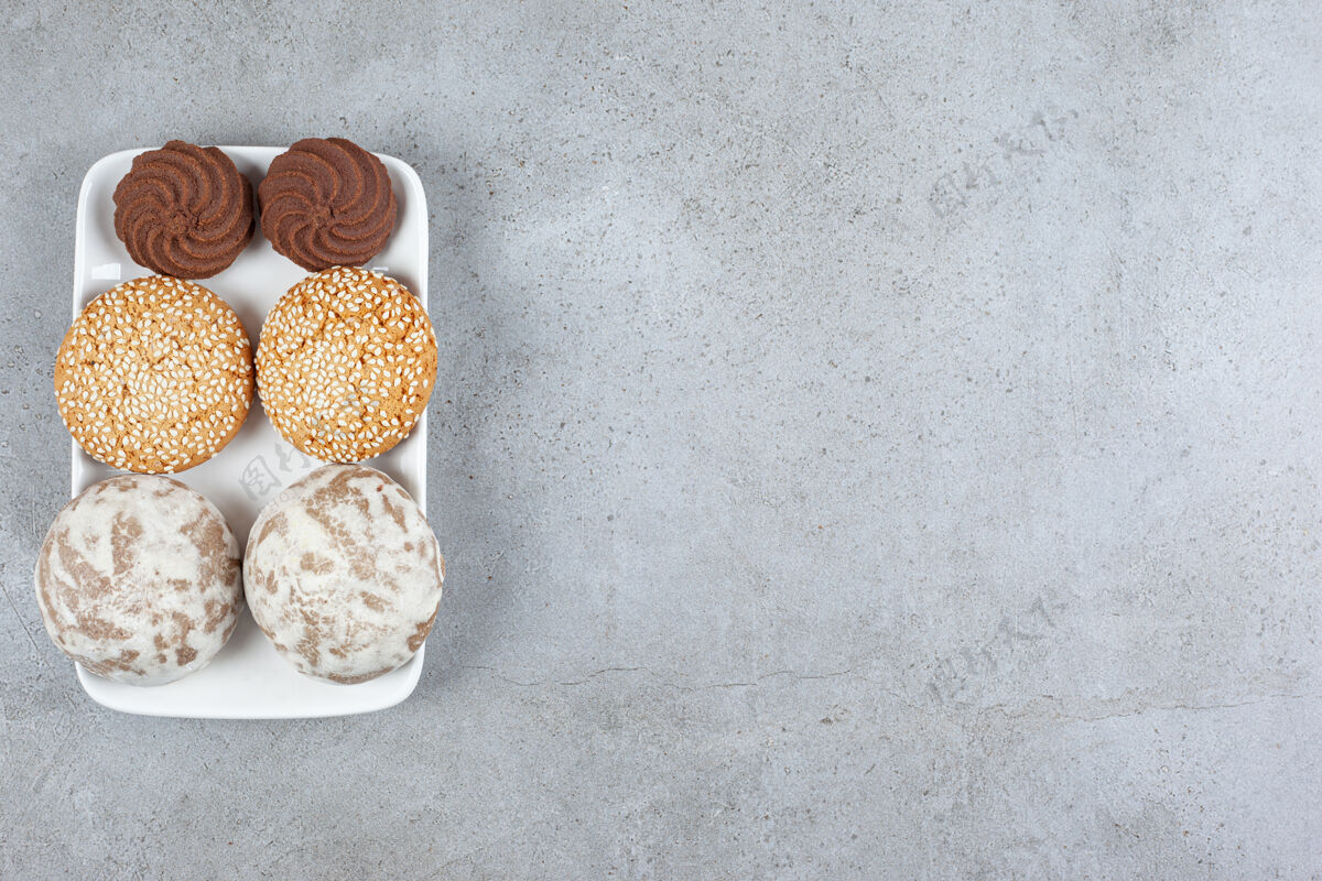 美食各种自制饼干放在大理石表面的盘子上小吃饼干甜点