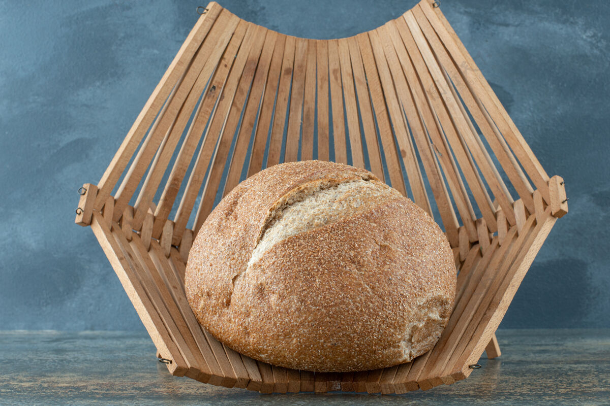 产品一个新鲜的棕色面包包放在木篮子里新鲜膳食烹饪