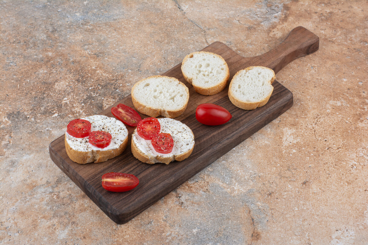 奶油面包加奶油和番茄片放在木板上新鲜吐司面包房