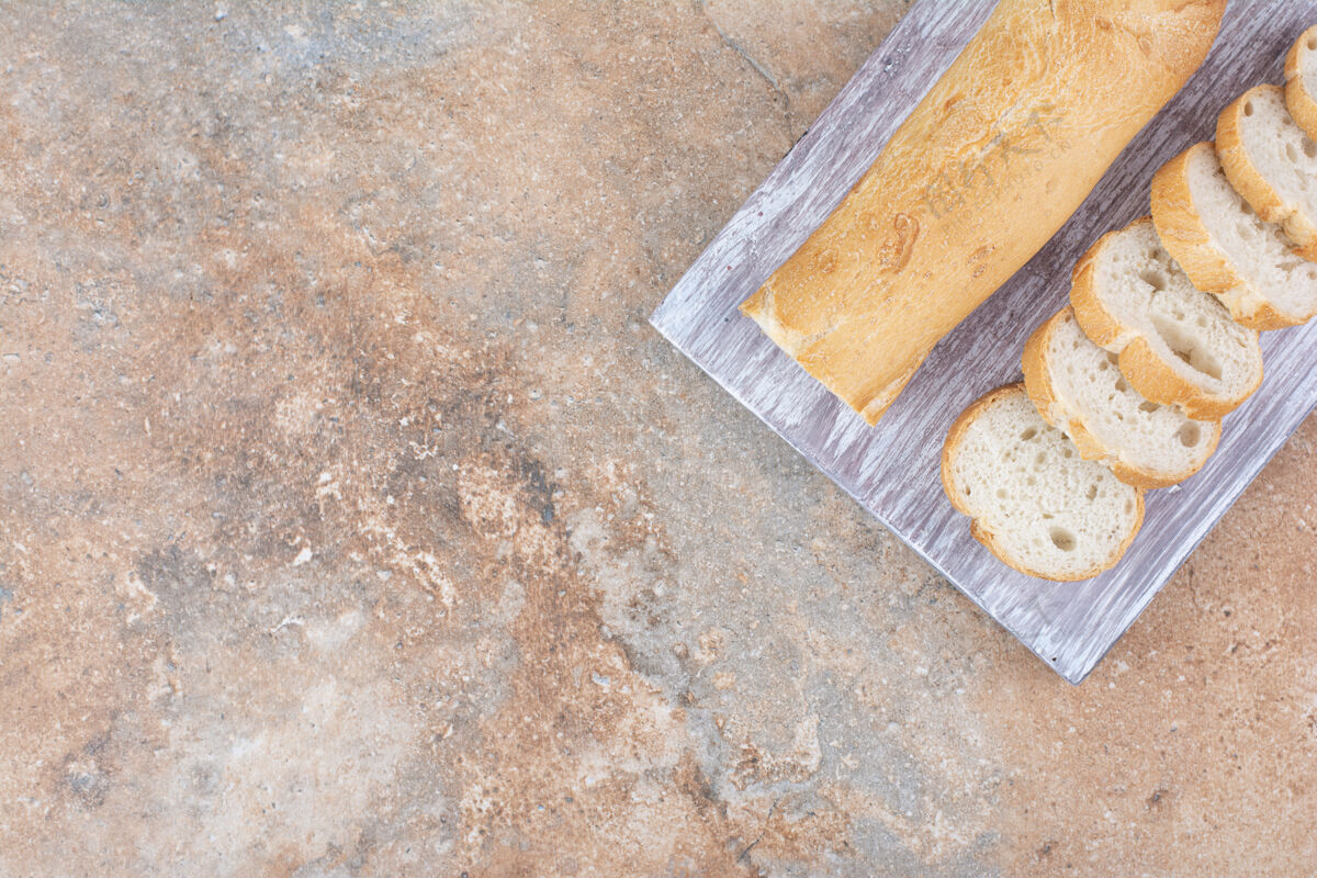 切的把新鲜的法式面包片放在木板上好吃的面包皮食品