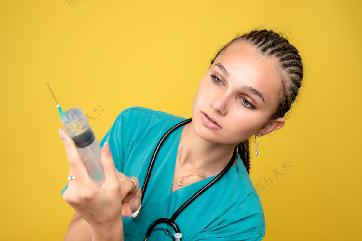 女医生黄色墙上的女医生正在准备巨大的注射剂病毒医院医疗