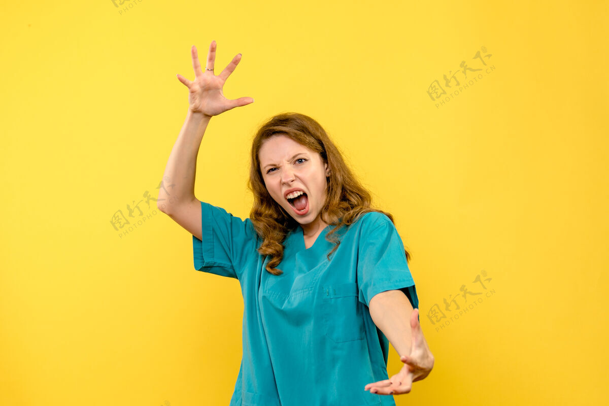 快乐黄色墙上尖叫的女医生的正视图黄色人病毒