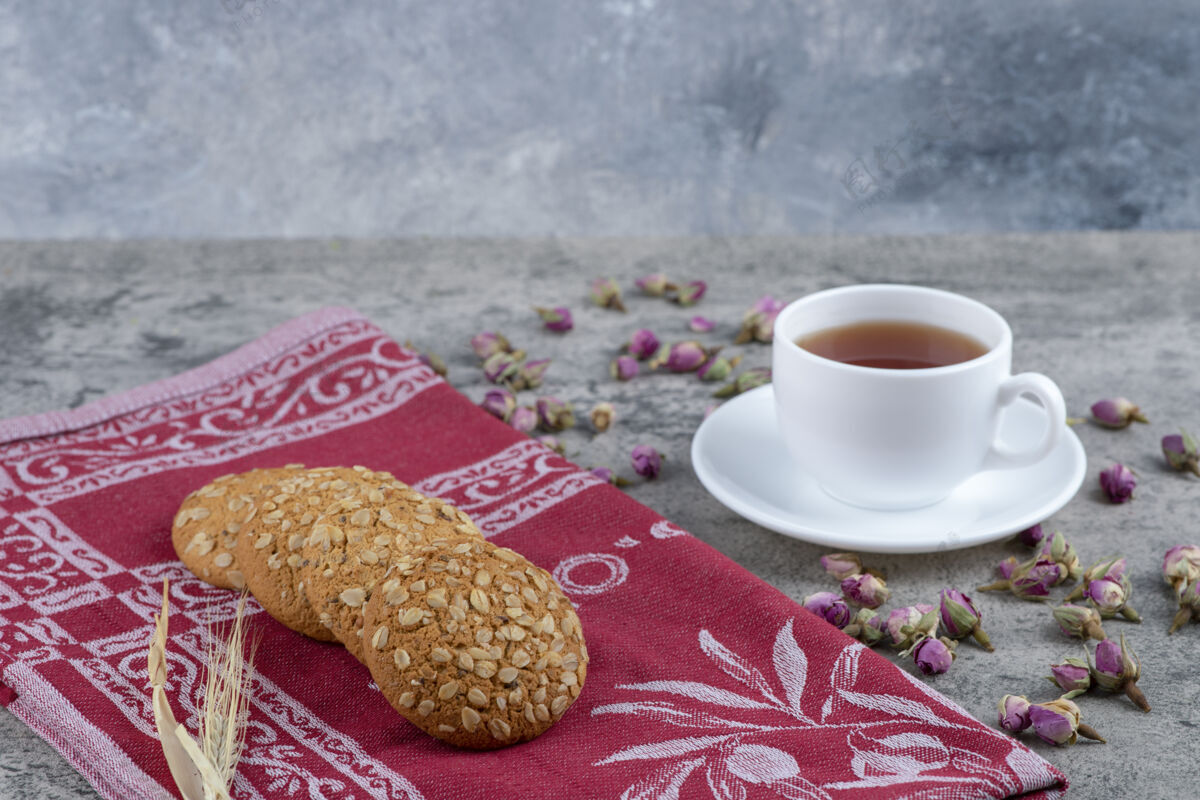 面包房燕麦片饼干和一杯红茶放在大理石表面甜点食品脆脆
