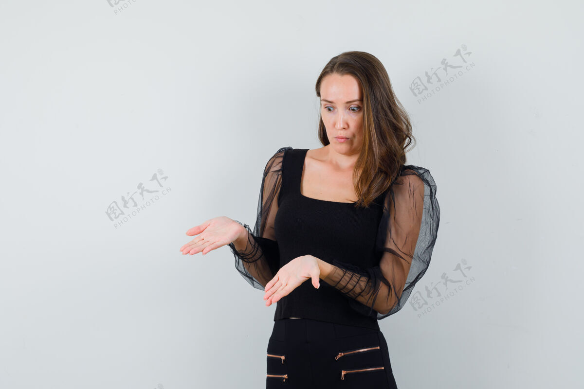 女性一个年轻女子 穿着黑色上衣 手掌张开 看起来很不安正视图手掌手什么
