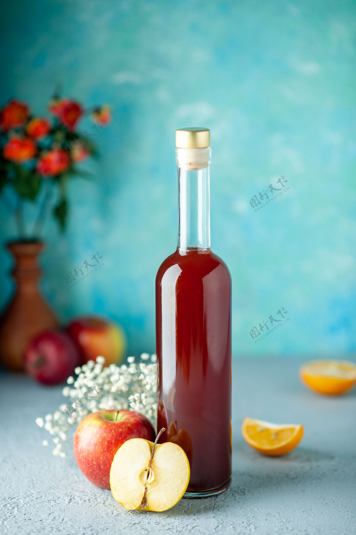 水果正面图蓝色墙上的红苹果醋食品饮料水果酒精葡萄酒酸颜色果汁酒精景观杯子
