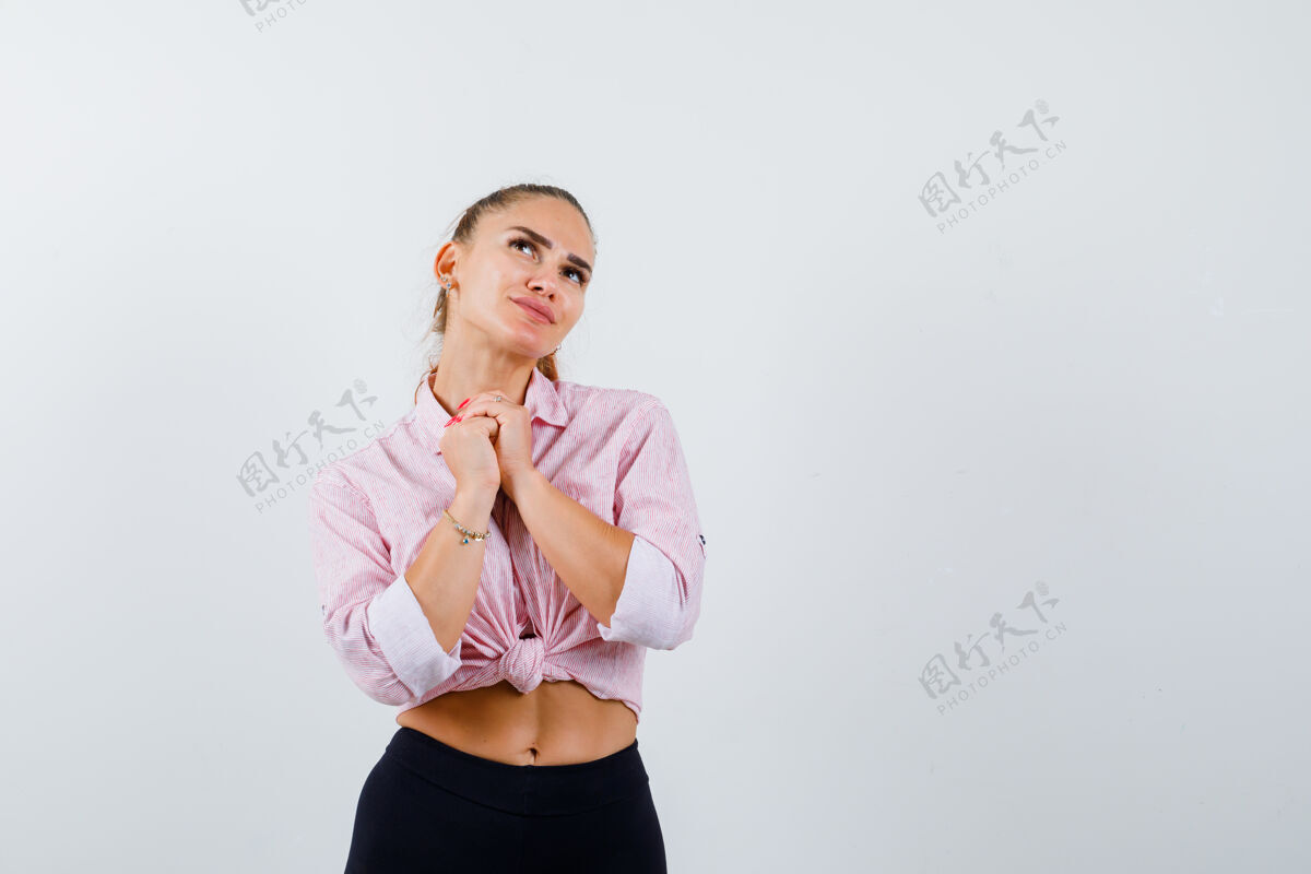 模特穿着休闲衬衫的年轻女性 双手合十 做着恳求的手势 看上去很平和 正前方魅力护理肖像
