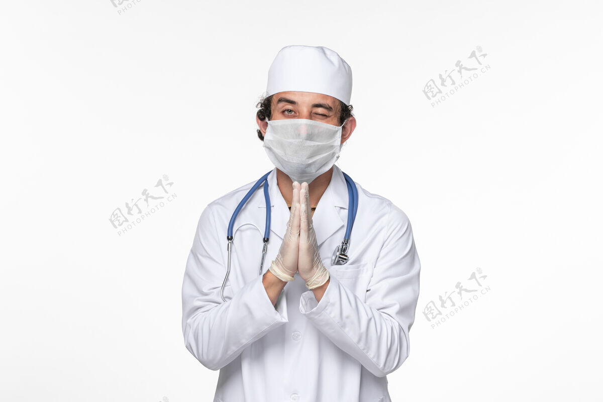 听诊器正面图男医生穿着医疗服 戴着无菌口罩 以防白墙病毒冠状病毒大流行疾病男性疾病医生