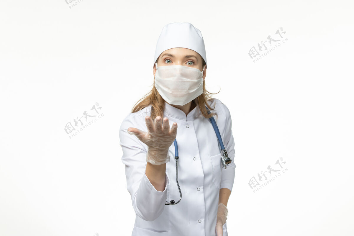 套装正面图女医生穿着医疗服 戴着口罩和手套 因白墙上冠状病毒病大流行健康冠状病毒-听诊器大流行冠状病毒防护