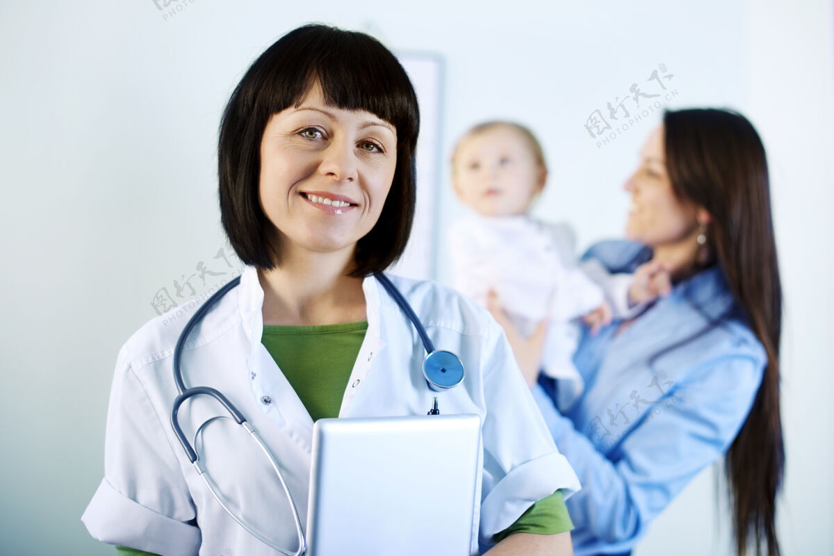 数字平板微笑的医生拿着药片父母医院快乐