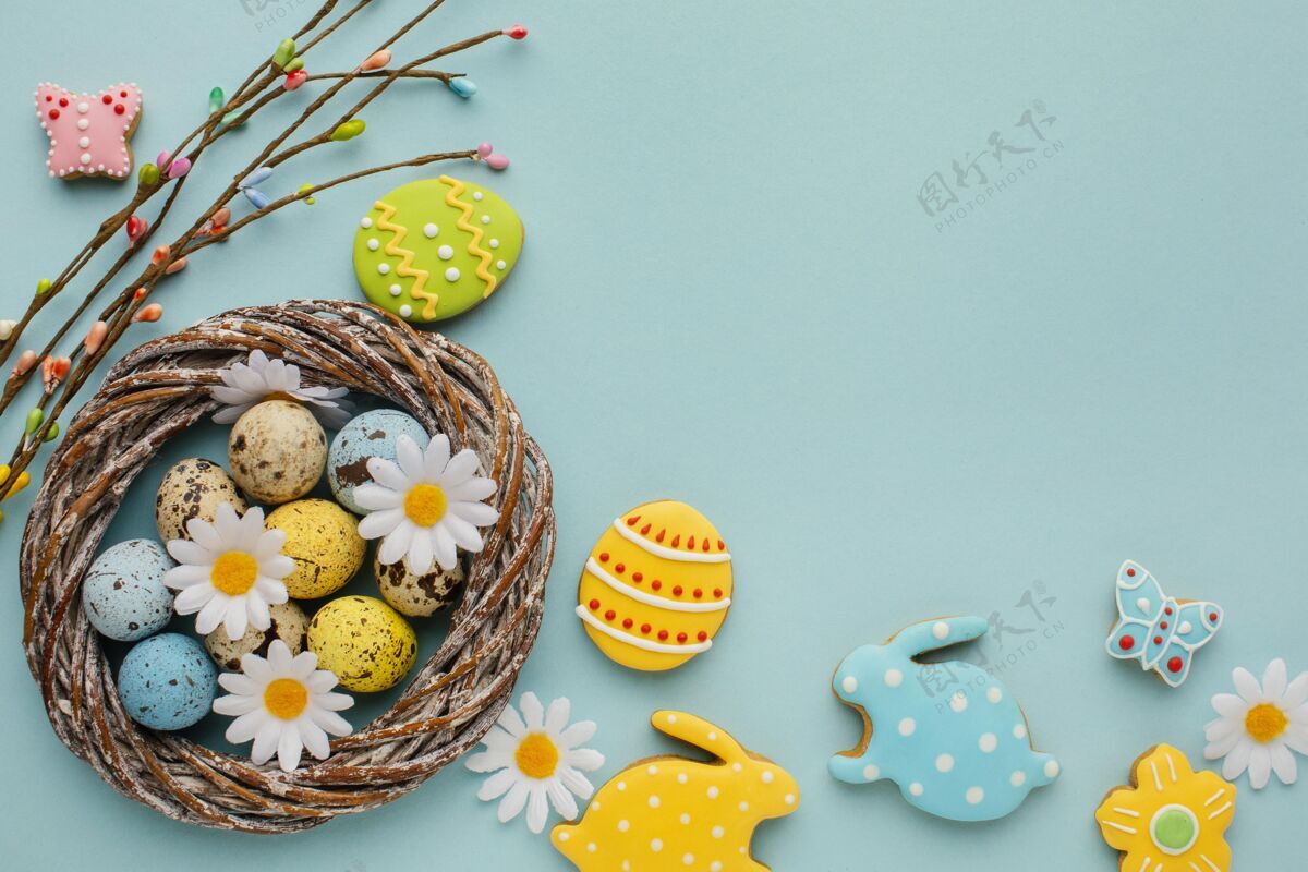 洋甘菊放在篮子里的复活节彩蛋 上面有洋甘菊花和兔子形状颜色花节日