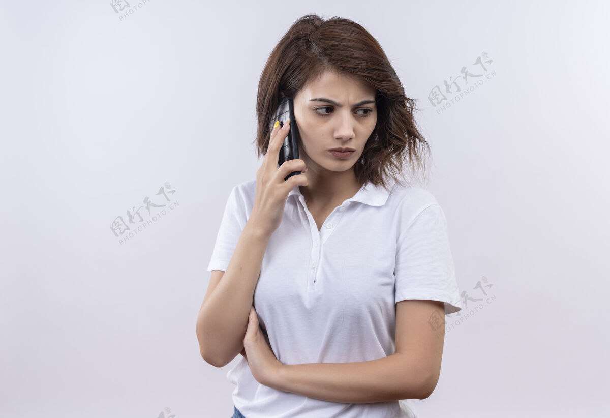 站一个留着短发 穿着白色马球衫 皱着眉头打电话的年轻女孩电话衬衫说话