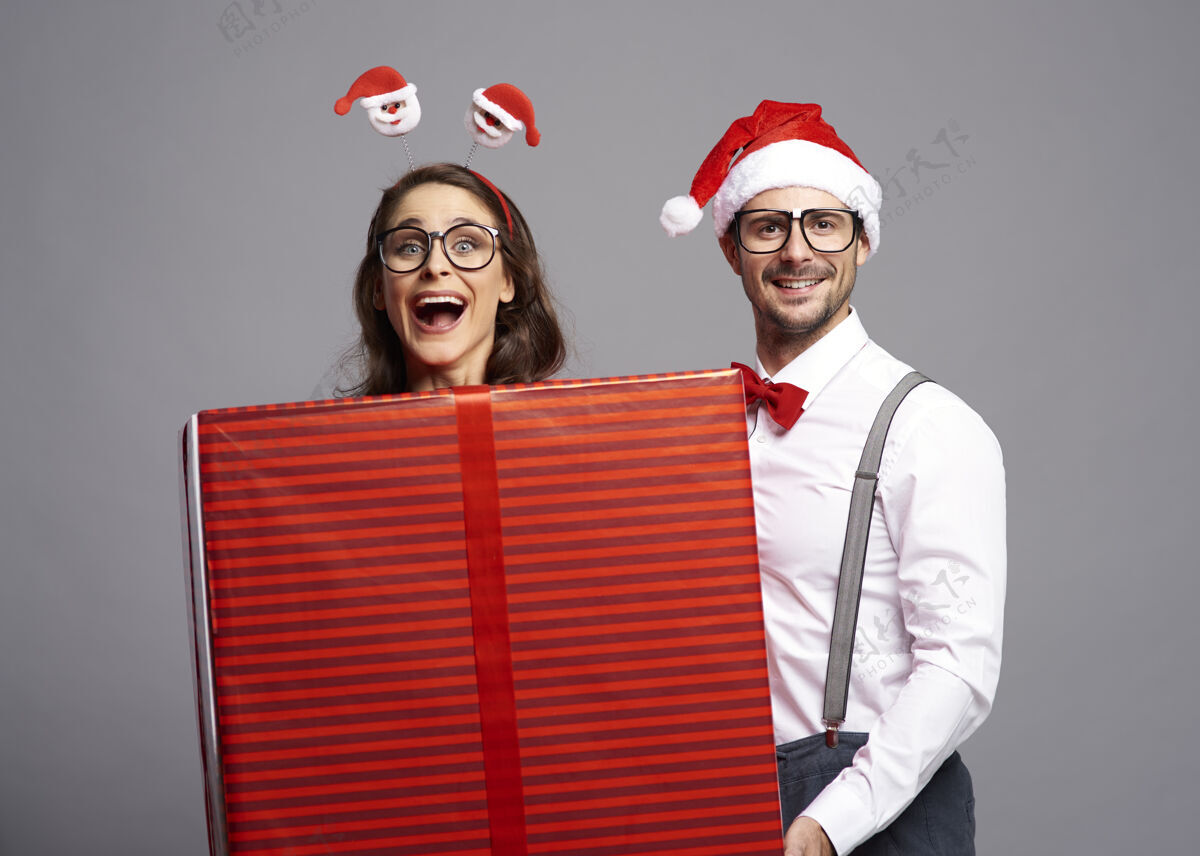 乐趣一对顽皮的情侣 带着圣诞礼物情侣圣诞礼物制造一个脸