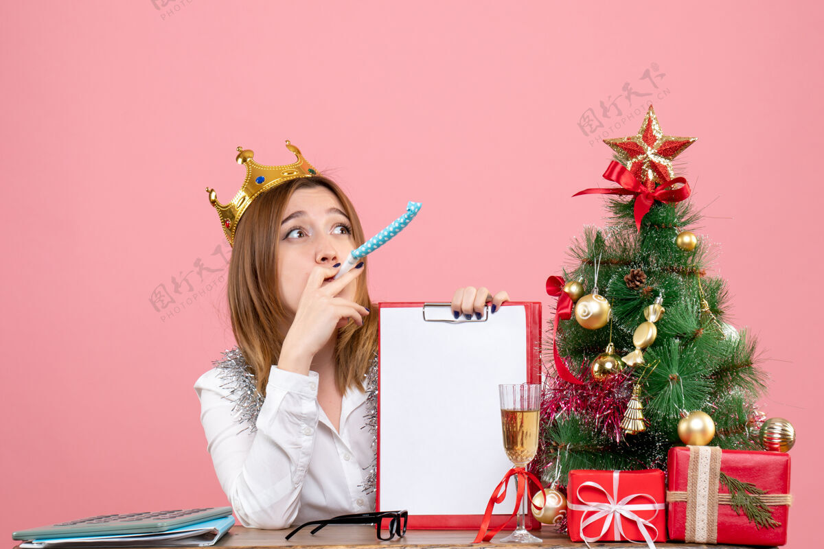 圣诞节戴皇冠的女工正面图 粉红色的文件说明工人时尚笔记