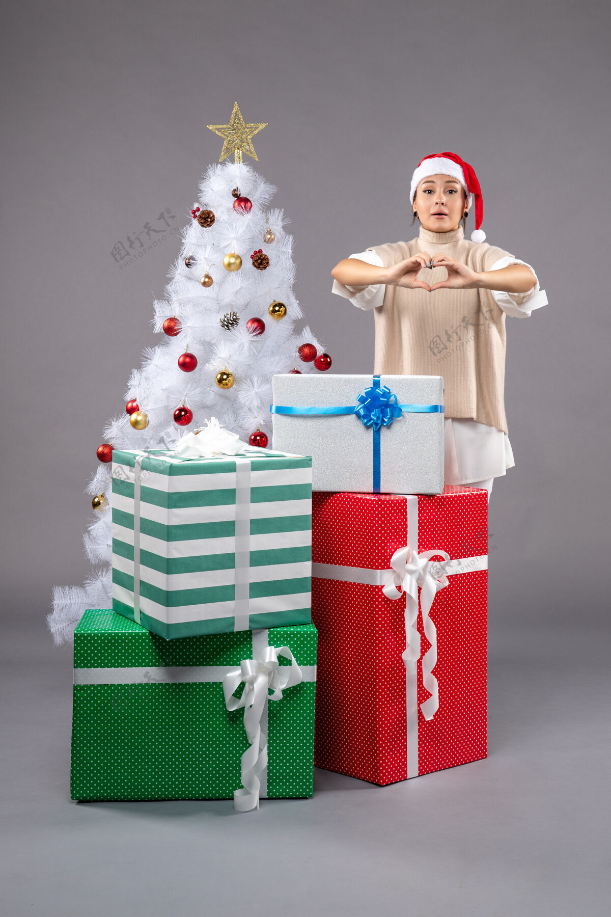 礼物在灰色的圣诞礼物周围有漂亮的女人灰色时尚圣诞