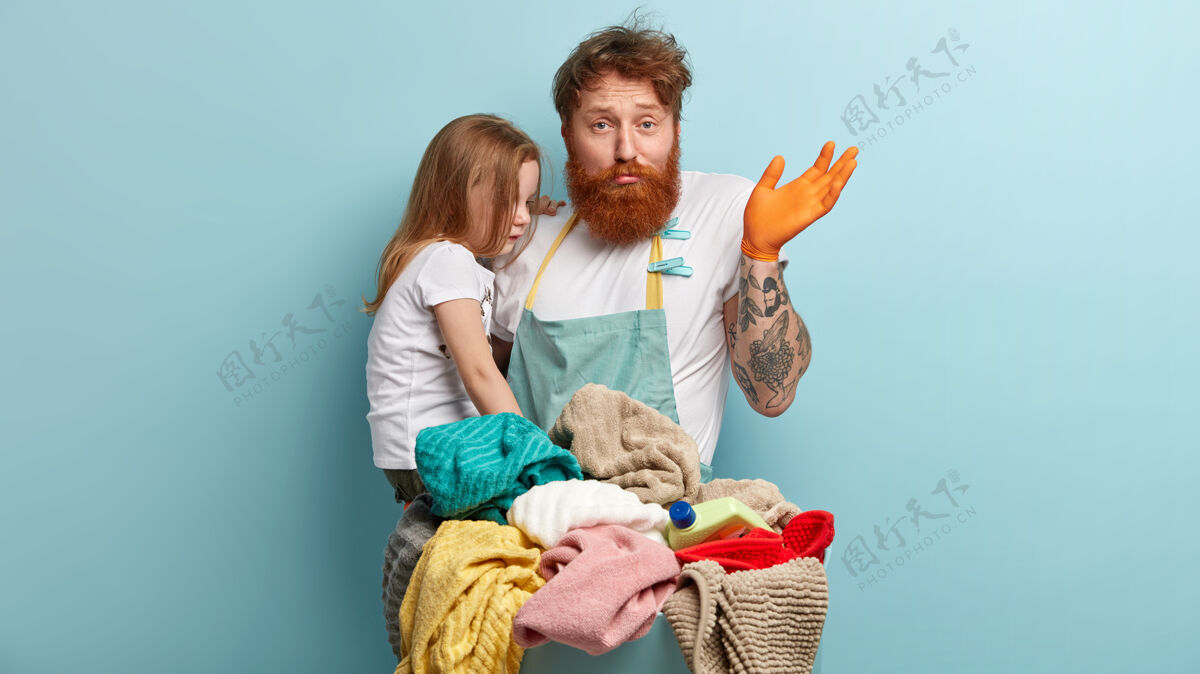 年轻人姜黄胡子男人抱着女儿洗衣服摆姿势毛巾人
